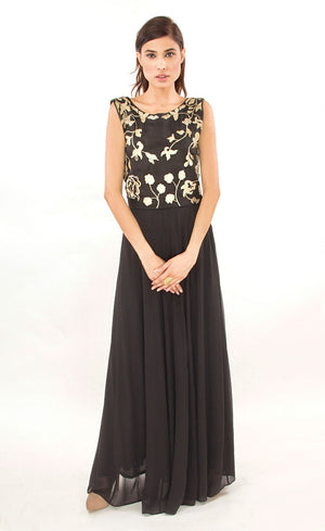 This black two-piece set is perfect for you to add into your collection. It comprises of a simple top with round neckline at the front and enhanced v-neckline at the back. It is intricately hand-embroidered with golden work silk threads, beads and sequins. This is further paired with a panelled skirt with perfect amount of flounce giving you a look that's both smart and eye-catching. 