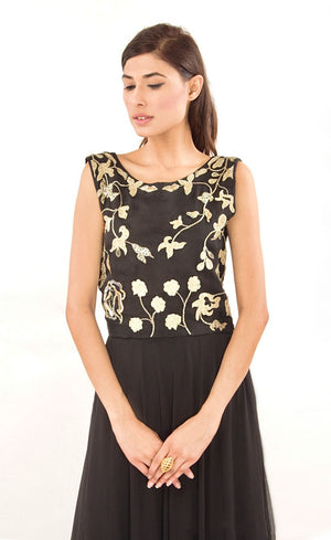 This black two-piece set is perfect for you to add into your collection. It comprises of a simple top with round neckline at the front and enhanced v-neckline at the back. It is intricately hand-embroidered with golden work silk threads, beads and sequins. This is further paired with a panelled skirt with perfect amount of flounce giving you a look that's both smart and eye-catching.