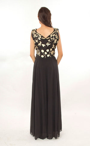 This black two-piece set is perfect for you to add into your collection. It comprises of a simple top with round neckline at the front and enhanced v-neckline at the back. It is intricately hand-embroidered with golden work silk threads, beads and sequins. This is further paired with a panelled skirt with perfect amount of flounce giving you a look that's both smart and eye-catching.