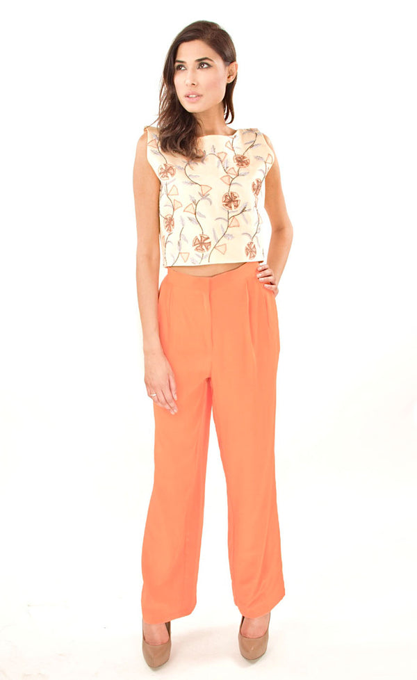 The muse here is wearing our trouser set. It is a butter yellow satin crop top embroidered with appliqué, silk threads and beads which is accompanied with dusty orange crepe trousers. This look will make you look modest and serene at the same time and is a must have in your wardrobe.