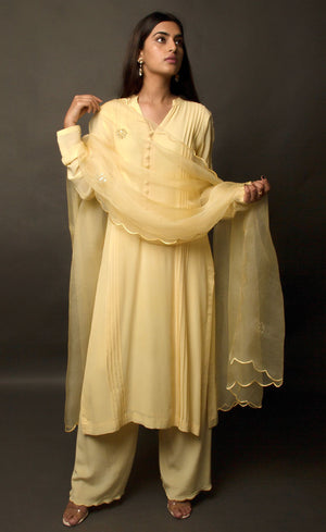 One of our favourite styles - This collection took its name 'classic minimalism' while this particular piece was being crafted. This kurta set (the very first piece to be crafted in this collection), flaunts its chic style with its embellished details along the length of the sleeves, a beautiful modern take on it. It carries many intimate details such as anchor thread being carefully stitched on the loop buttoned placket neckline and across the slim cuffs, definitely making it a wardrobe essential.