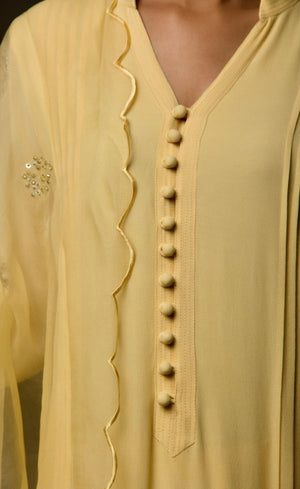 One of our favourite styles - This collection took its name 'classic minimalism' while this particular piece was being crafted. This kurta set (the very first piece to be crafted in this collection), flaunts its chic style with its embellished details along the length of the sleeves, a beautiful modern take on it. It carries many intimate details such as anchor thread being carefully stitched on the loop buttoned placket neckline and across the slim cuffs, definitely making it a wardrobe essential.