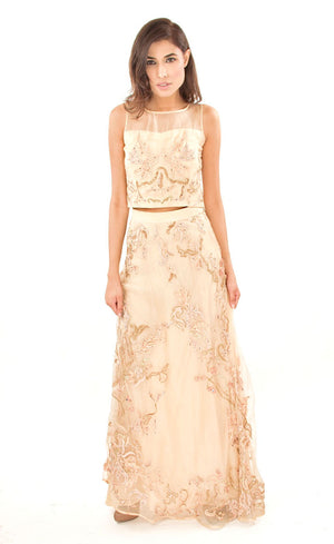 This is our champagne cropped top with A line skirt set. It is fully embroidered with silk threads, beads, sequins, golden work and appliqué details. This skirt set is intricately embroidered with 24 different embroidery techniques done all over the lehenga skirt, truly making it a one of a kind outfit. This as a whole presents a delicate feminine look with a carefree and effortless ensemble, perfect for all occasions.