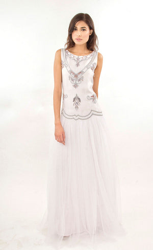 The muse here is wearing our cloud white tulle net gown with it's upper body intricately hand-embroidered with silk threads, beads, sequins in a silver grey palette. The gown gives you the look and confidence you deserve and thus is ideal for a beach wedding or any other evening event.