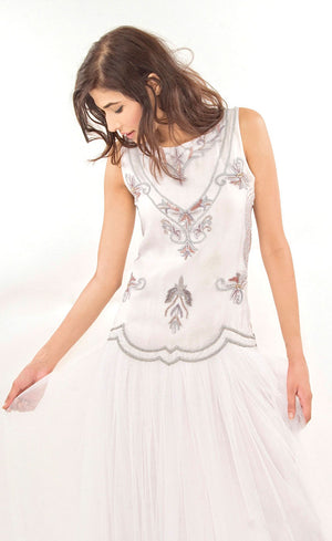 The muse here is wearing our cloud white tulle net gown with it's upper body intricately hand-embroidered with silk threads, beads, sequins in a silver grey palette. The gown gives you the look and confidence you deserve and thus is ideal for a beach wedding or any other evening event.