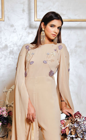 A nude jumpsuit being modelled by an Indian fashion model highlighting its elegant embroidery. 