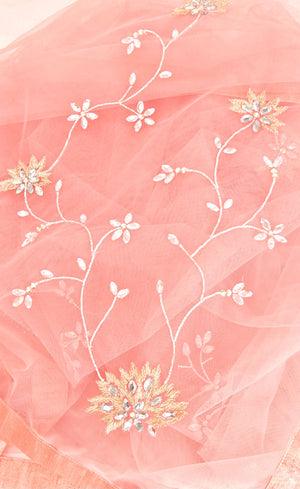 This is our beautiful tulle net dupatta with intricate hand-embroidered motifs all over the body with heavy embellished corners with crystals, beads and golden working further finished with a coordinating silk border. This dupatta is effortlessly elegant with it's minimal work thus will add up to your charm.