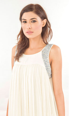 The muse here is wearing our ivory super flowy and classic gown that is hand embroidered using beads around the arms to give a structured look to the silhouette, pin-tucked from top to bottom and is gathered around the upper yoke. Perfect for the beach or city, this dress will show off your sense of style, sophistication and flair for fun.