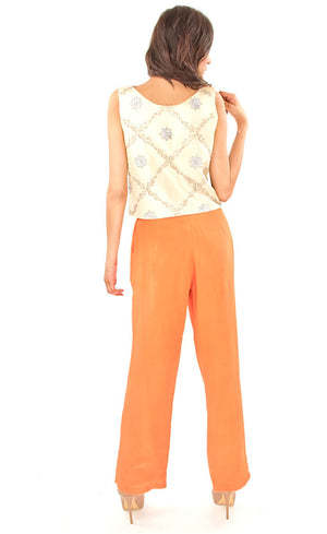 The muse here is wearing our top-pant set - a light beige silk top embroidered with silk threads and sequin which is paired with an orange silk crepe pants. This look will make you look modest and serene at the same time and is a must have in your wardrobe.