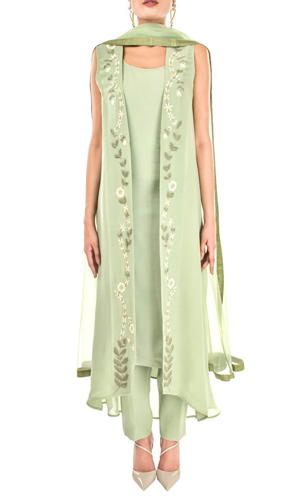 The muse here is wearing our light olive embroidered jacket suit set. This understated jacket suit set is enough to take your fashion game up this season. The front embroidery features a beautifully elegant zardozi embroidery all over the front opening panels on the outer jacket/gilet. This suit set features a round-neck slip underneath paired with crepe pants, and dupatta finished with a coordinating raw-silk border.