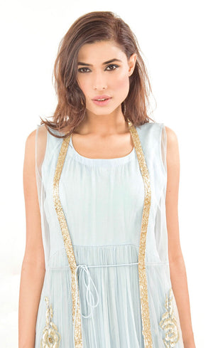 The muse here is wearing our floor length gown with an embroidered gilet / jacket. Embracing the era of comfort this dress is nothing short of luxury and glamour. It is a silk chiffon gown with a tulle net jacket overalls which is fully embroidered in our signature gota appliqué, silk threads, beads and sequins embroidery on the front and pressed gota at the border.