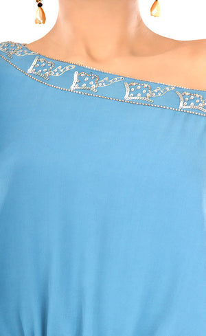 All eyes will be on you in this mykonos blue, exquisitely detailed one off shoulder dress. This dress features an elegant and effortlessly trendy one off shoulder neckline, carefully embroidered with beads and sequins giving a subtle and sophisticated look that exudes glamour. It has full sleeves that are gathered around the cuff, slightly ruched drawstring insertion along the waistline and a high slit at one of it's sides making this dress suitable for any occasion.