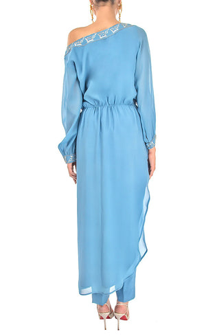 All eyes will be on you in this mykonos blue, exquisitely detailed one off shoulder dress. This dress features an elegant and effortlessly trendy one off shoulder neckline, carefully embroidered with beads and sequins giving a subtle and sophisticated look that exudes glamour. It has full sleeves that are gathered around the cuff, slightly ruched drawstring insertion along the waistline and a high slit at one of it's sides making this dress suitable for any occasion.