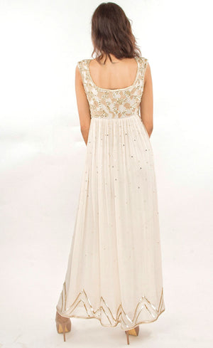 This is a simple and effortlessly elegant pearl silk beaded gown with a beautiful empire waist line partially embroidered with beads, sequins and gold work across the yoke area in the front as well as the rear. This flowy gown allows you to feel all the freedom around and is finished with gota appliqué work along the bottom flare.