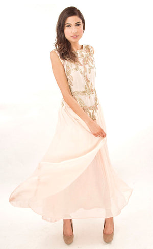 The muse here is wearing our powder pink gown. This gown is fully embroidered with beads, sequins and gold work on the front as well as the back. It beautifully gathers around the waist creating an elegant flare for you when you walk. This classic gown with it's comforting style is a perfect companion for an evening event needs.