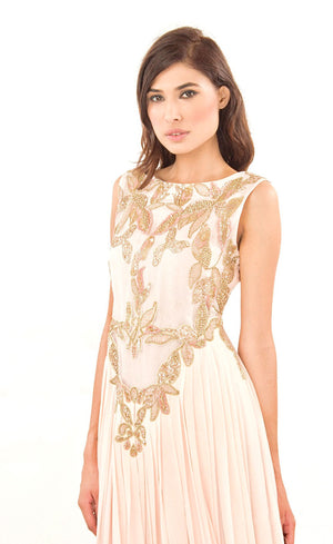 The muse here is wearing our powder pink gown. This gown is fully embroidered with beads, sequins and gold work on the front as well as the back. It beautifully gathers around the waist creating an elegant flare for you when you walk. This classic gown with it's comforting style is a perfect companion for an evening event needs.