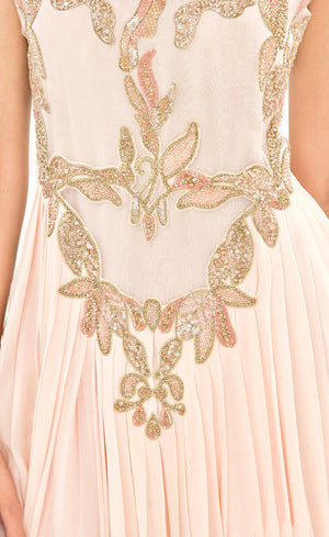 The muse here is wearing our powder pink gown. This gown is fully embroidered with beads, sequins and gold work on the front as well as the back. It beautifully gathers around the waist creating an elegant flare for you when you walk. This classic gown with it's comforting style is a perfect companion for an evening event needs. 