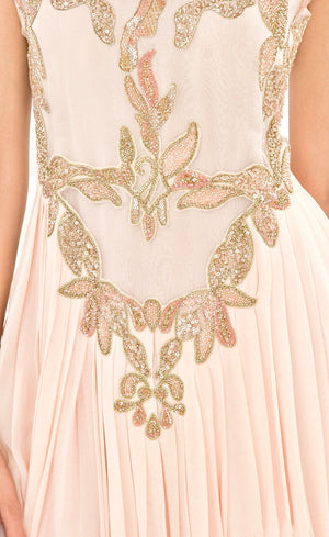 The muse here is wearing our powder pink gown. This gown is fully embroidered with beads, sequins and gold work on the front as well as the back. It beautifully gathers around the waist creating an elegant flare for you when you walk. This classic gown with it's comforting style is a perfect companion for an evening event needs.