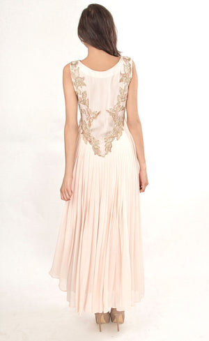 The muse here is wearing our powder pink gown. This gown is fully embroidered with beads, sequins and gold work on the front as well as the back. It beautifully gathers around the waist creating an elegant flare for you when you walk. This classic gown with it's comforting style is a perfect companion for an evening event needs.