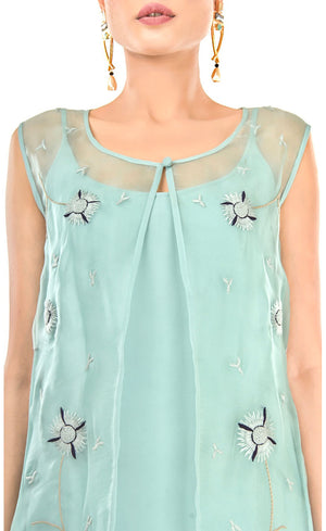 The muse here is wearing our sea green dress with an embroidered jacket. Embracing the era of comfort this dress is nothing short of luxury and glamour. The jacket carries subtle thread embroidery just enough to enhance it subtly. It is accompanied with a strapped flowy cupro slip underneath, just to make it elegantly sheer.