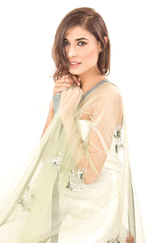 This is our beautiful tulle net dupatta with intricate hand-embroidered beaded motifs all over the body further finished with a coordinating raw silk border. This dupatta is effortlessly elegant with it's minimal work thus will add up to your look. 
