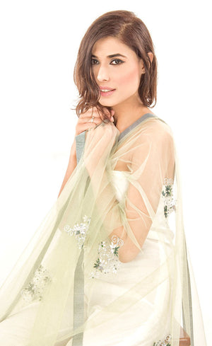 This is our beautiful tulle net dupatta with intricate hand-embroidered beaded motifs all over the body further finished with a coordinating raw silk border. This dupatta is effortlessly elegant with it's minimal work thus will add up to your look.