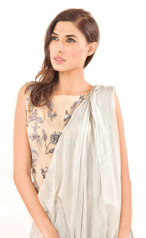 The muse here is wearing our silver grey ready to wear sari drape with trousers. It is a perfect look to spice up your traditional game to something really trendy. This comprises of a silk sari drape paired with a silk organza intricately embroidered crop top hand embroidered with silk threads, sequins, beads and silver grey work. The outfit is paired with slim crepe trousers.