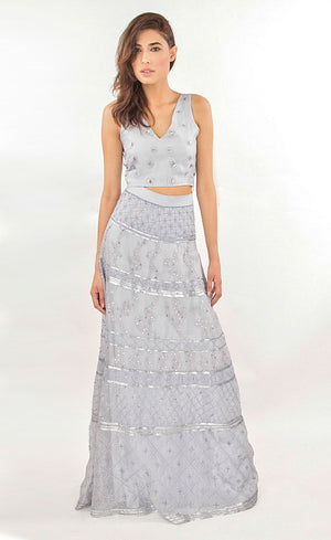 This is our soft mauve fully embellished organza lehenga skirt set. This two-piece set comprises of a simple v-neckline top, intricately hand-embroidered with silk-threads and sequins. This is further paired with a flared skirt which too is beautifully embroidered with silk-threads and sequins. It is ideal for a beach wedding, engagement or a minimal bride. It also has a custom-made dupatta available to further enhance the whole look.