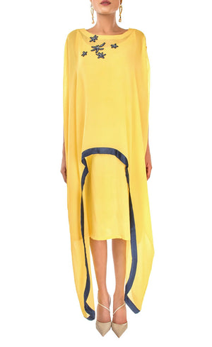 The muse here is wearing our sunflower yellow cape dress crafted in cupro georgette. Elegant and effortlessly trendy, this cape dress will keep you looking fabulous all day and night. This dress accompanies a slightly fitted inner silhouette, a fashion-forward cape embroidered with deep blue beads and sequins making it an elegant resort and holiday lounge style and a subtle back.