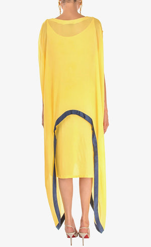 The muse here is wearing our sunflower yellow cape dress crafted in cupro georgette. Elegant and effortlessly trendy, this cape dress will keep you looking fabulous all day and night. This dress accompanies a slightly fitted inner silhouette, a fashion-forward cape embroidered with deep blue beads and sequins making it an elegant resort and holiday lounge style and a subtle back.