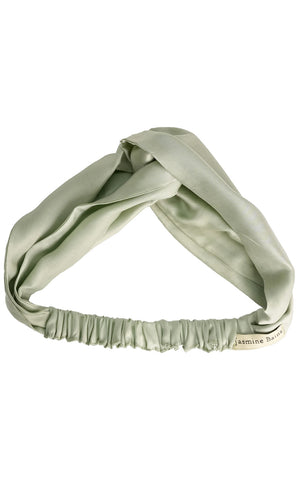 Green headband with a twisted design on a white background