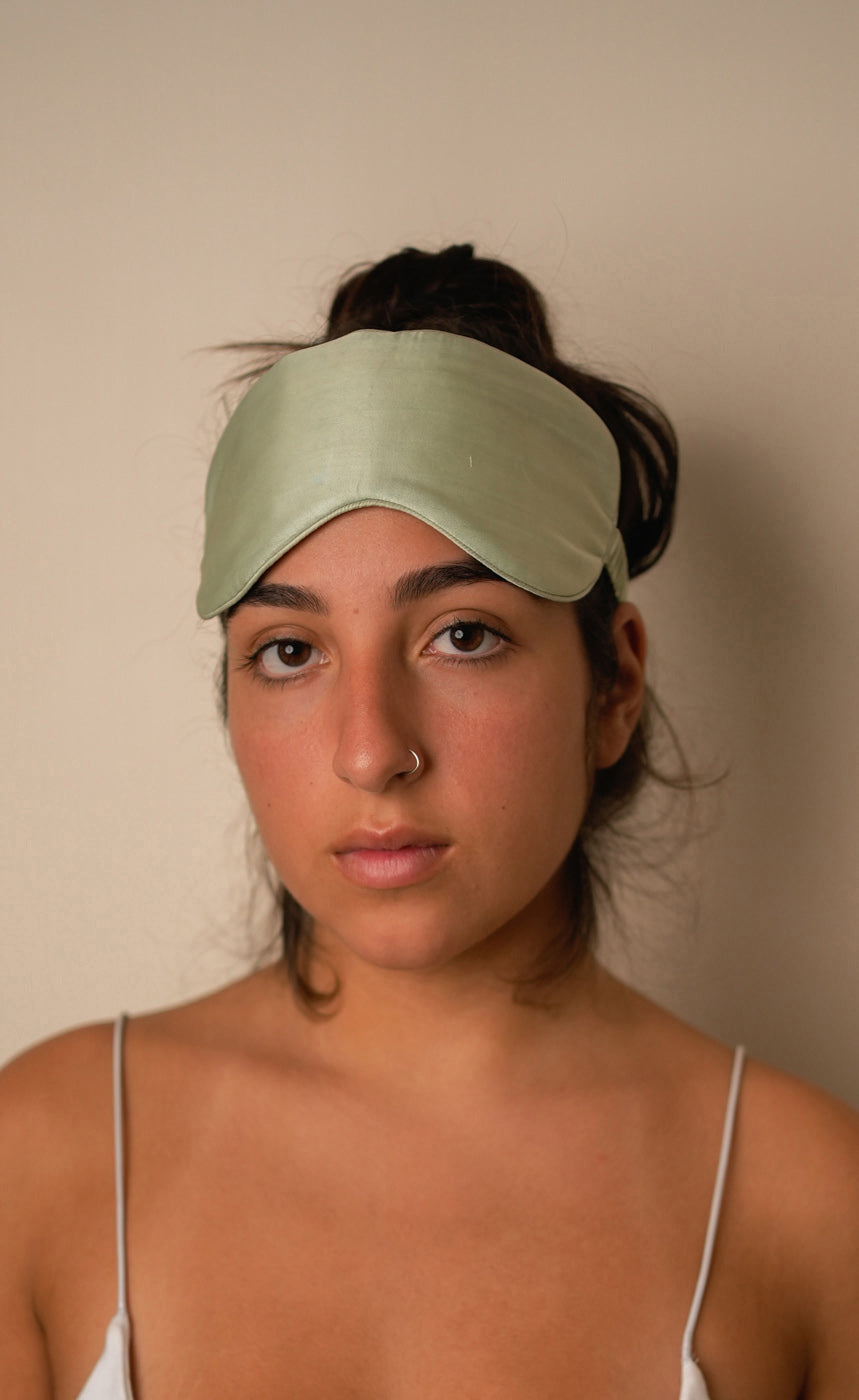 Light green fabric with a headband and scrunchie on a matching background