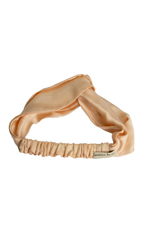 Beige satin headband on a white background