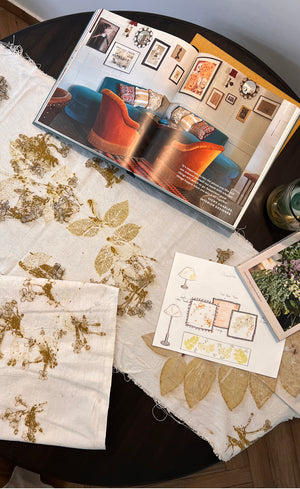 Eco-printing design process - botanical printed fabric swatches with golden leaf impressions alongside mood sketches and inspiration. 