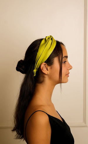 Model wearing lime green mulberry silk single knot headband, Jasmine Bains handcrafted silk accessory