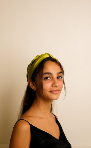 Olive green silk twist headband worn on model, handcrafted by Jasmine Bains