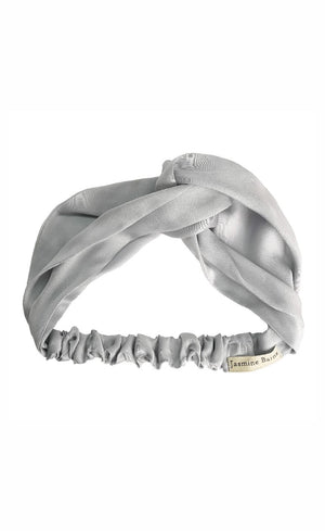 Silver headband with a textured pattern on a white background