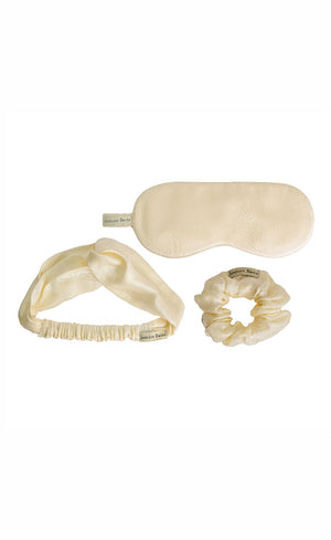 Ivory Bemberg satin sleep mask, knotted headband and a scrunchie laid flat showing fabric detail
