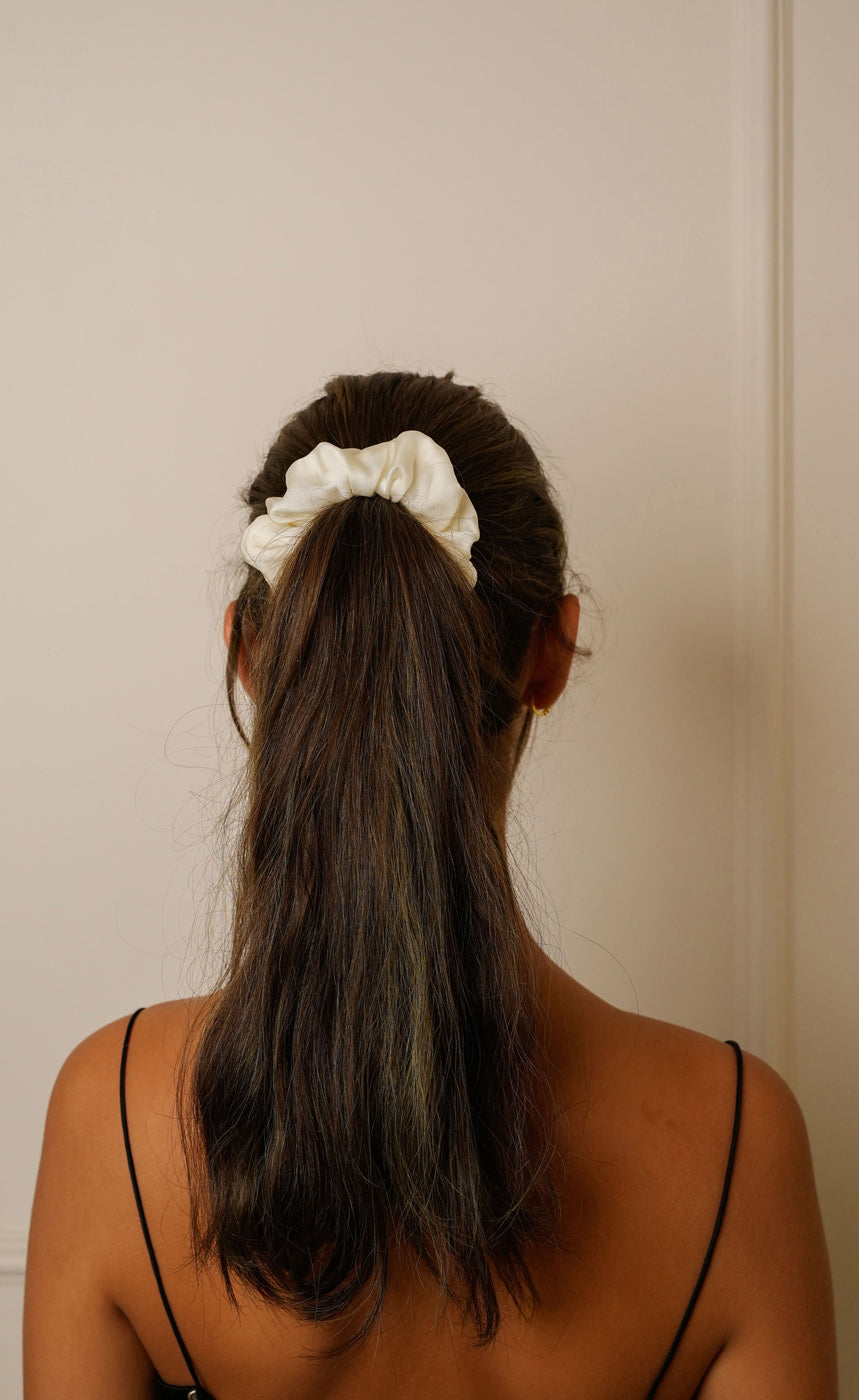 Woman wearing Ivory satin scrunchie black top — Jasmine Bains no-crease Bemberg satin hair accessory