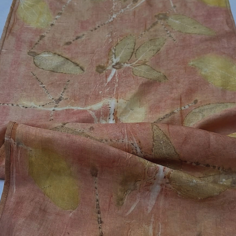 Close-up of a fabric with leaf pattern on a pink background