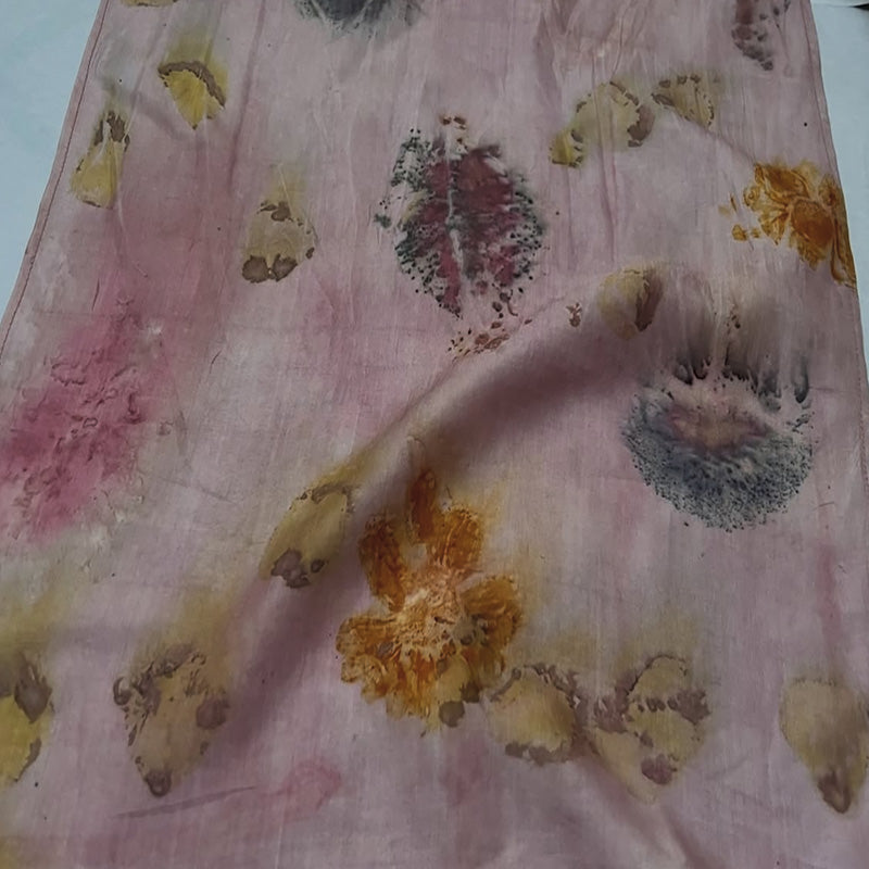 Floral patterned fabric with yellow flowers on a pink background