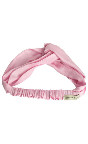 High quality pink satin headband against a clean white background