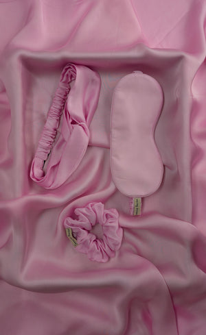 Pink hair accessory set on a pink fabric background