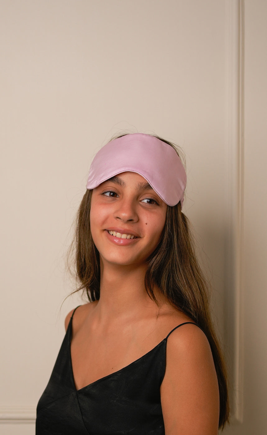 Pink wide sleeping eye mask on a model