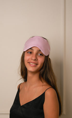 Pink wide sleeping eye mask on a model