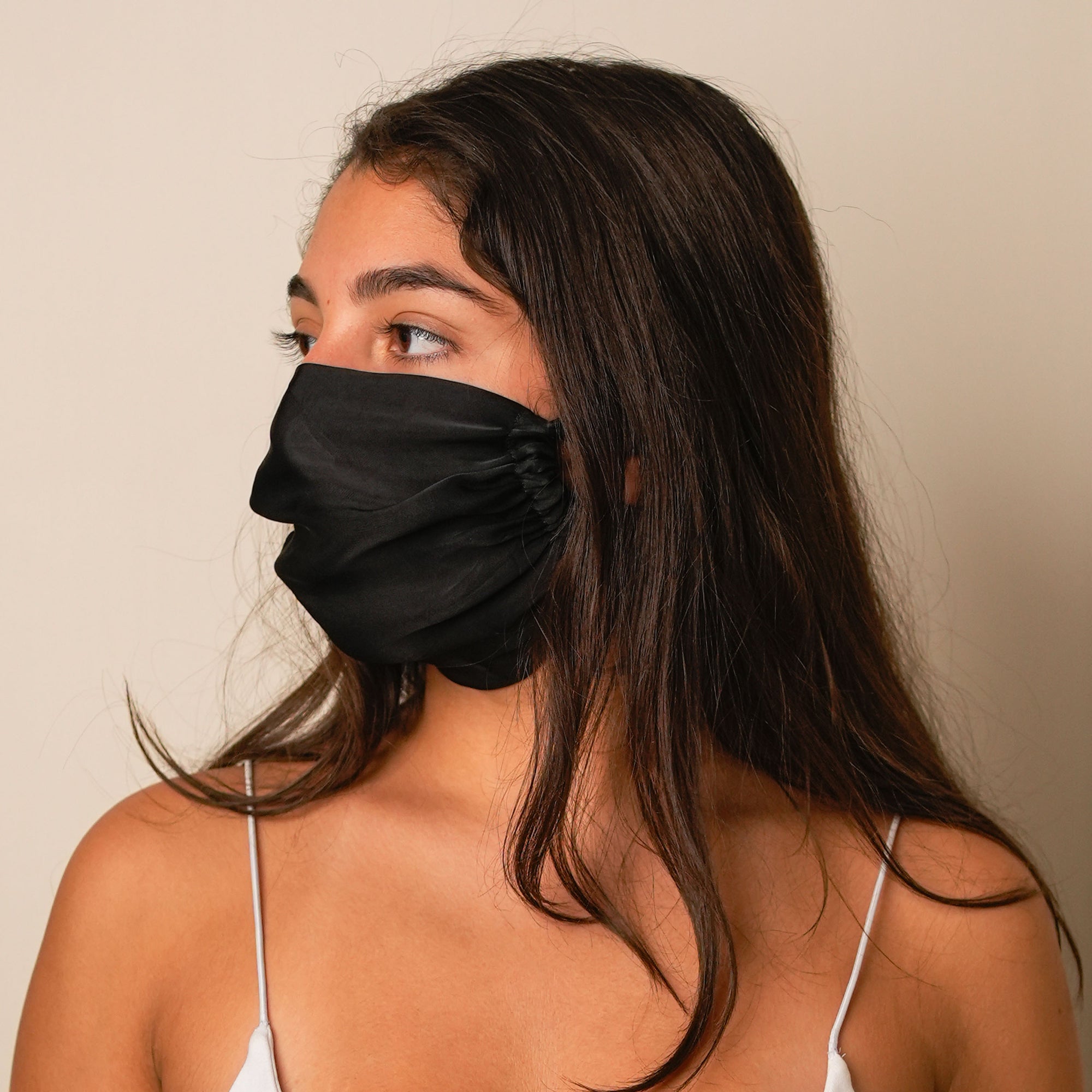 Close-up of a stylish black silk mask showcasing its texture.
