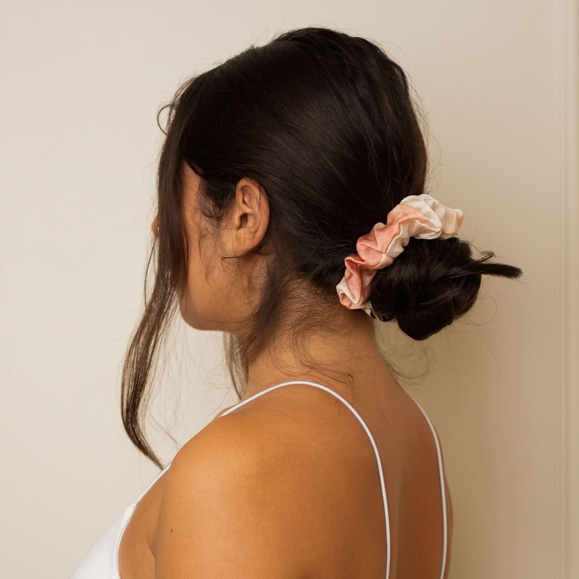 Close-up of a marble-rust mulberry silk scrunchie for hair.