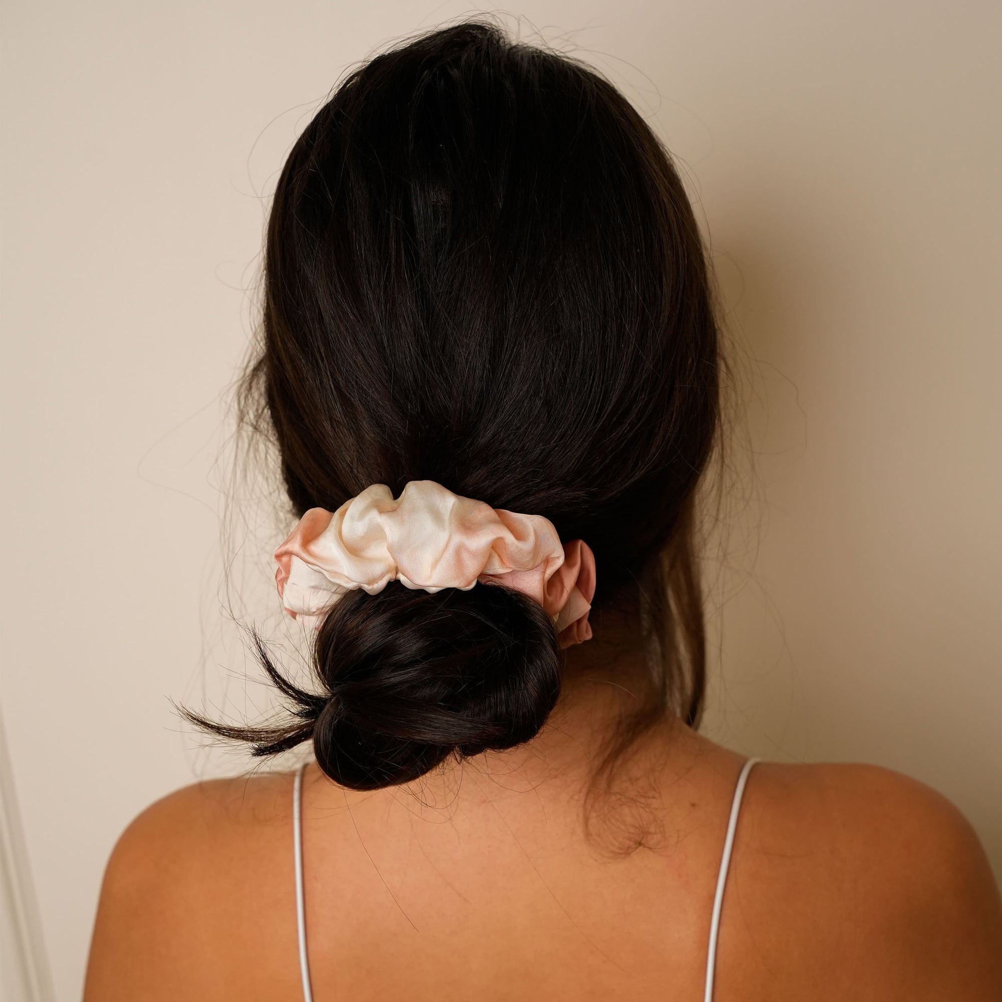 Jasmine rust scrunchie displayed on a marble surface.