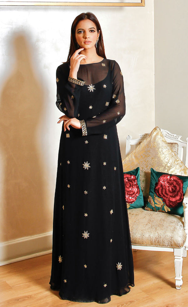 A gorgeous floor length black silk georgette gown beautifully embellished with minimal golden starry motifs embroidery. 