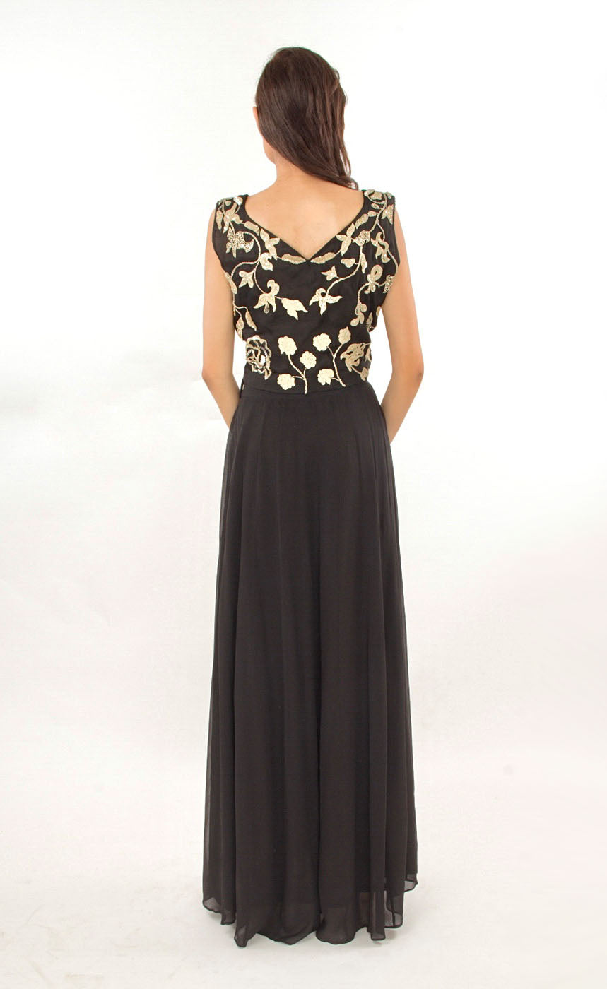 This black two-piece set is perfect for you to add into your collection. It comprises of a simple top with round neckline at the front and enhanced v-neckline at the back. It is intricately hand-embroidered with golden work silk threads, beads and sequins. This is further paired with a panelled skirt with perfect amount of flounce giving you a look that's both smart and eye-catching. 